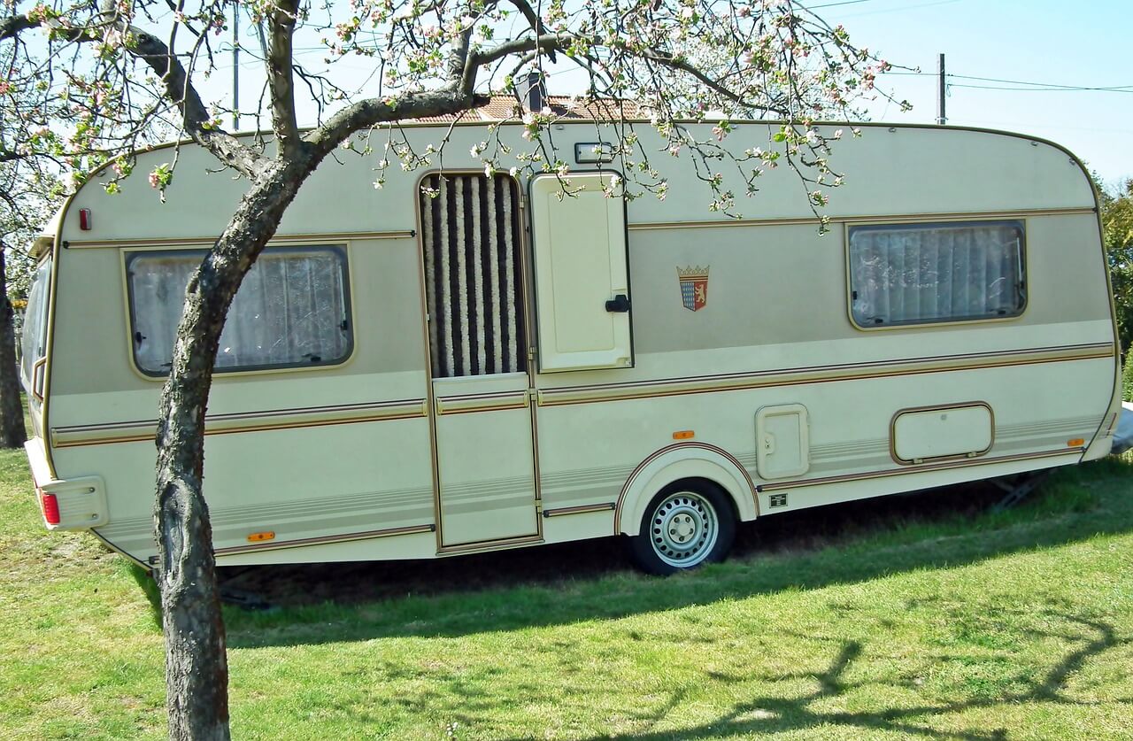 a trailer under a blooming tree