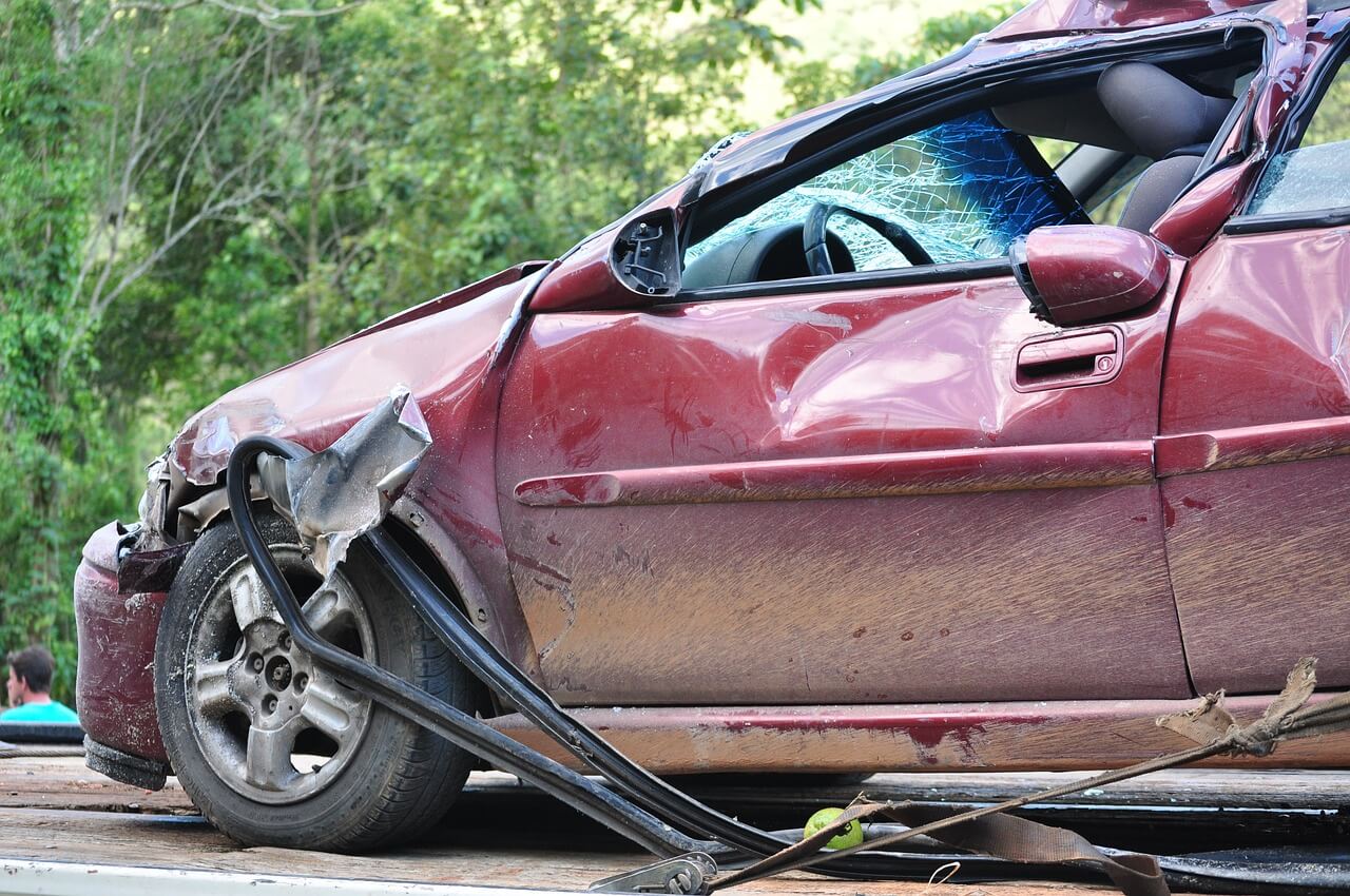 a crashed car with a damaged door