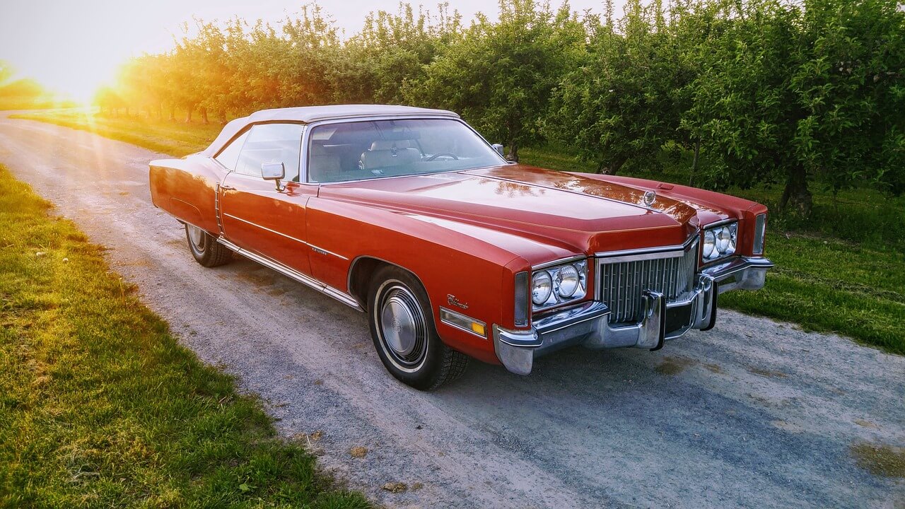 a red Cadillac Eldorado on the road