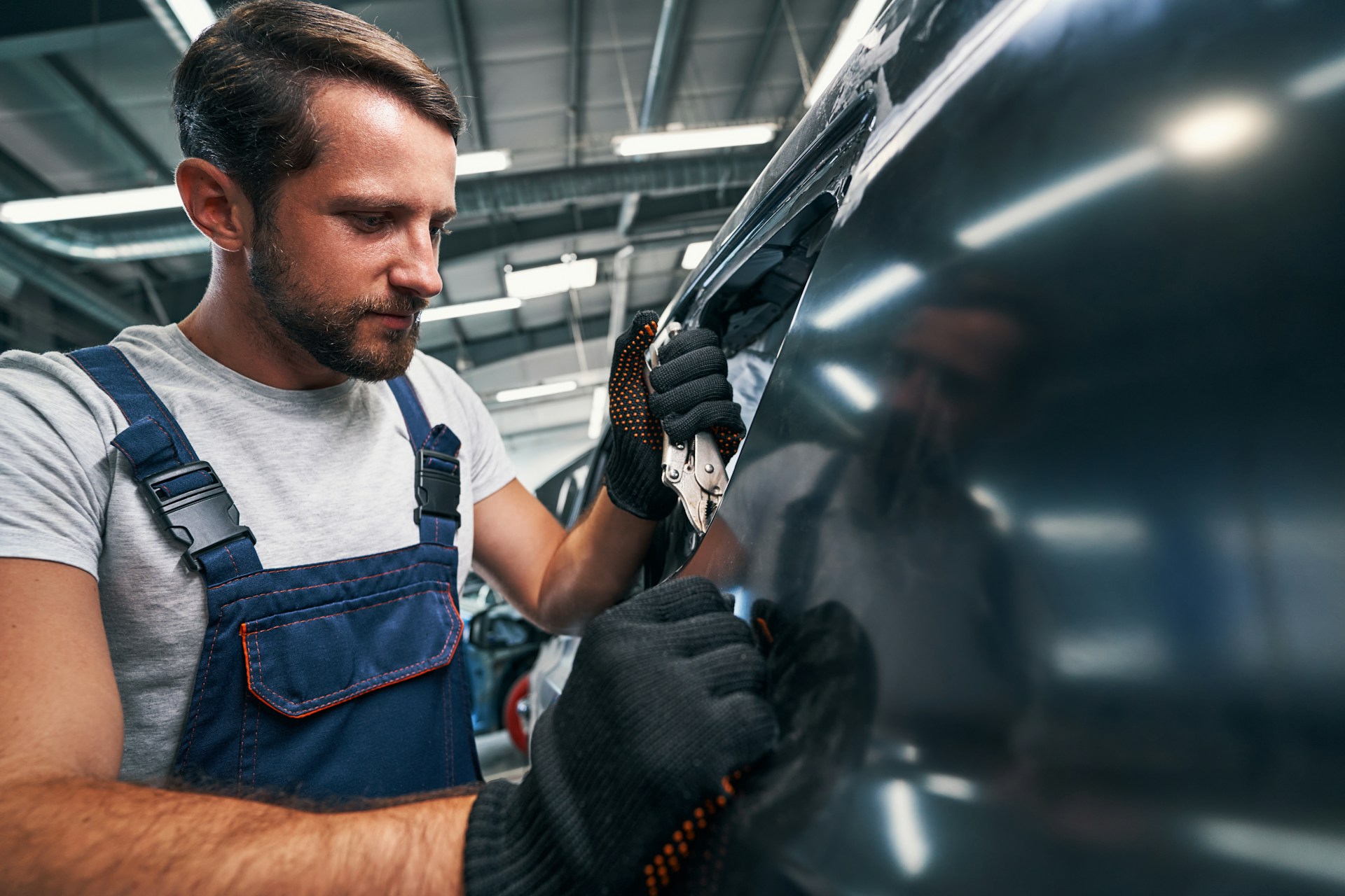 car mechanic checking a used car