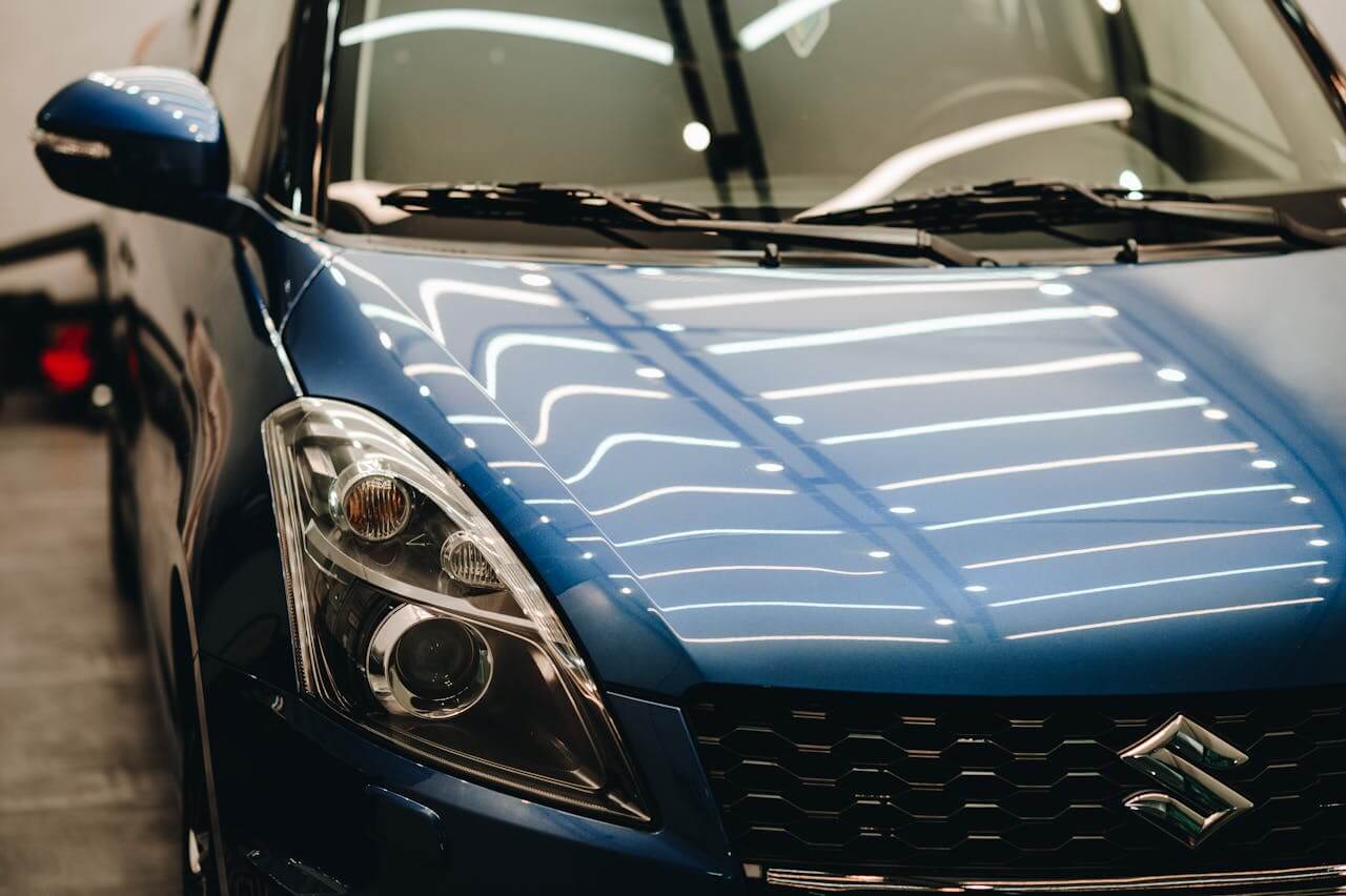 a blue Suzuki car in a showroom