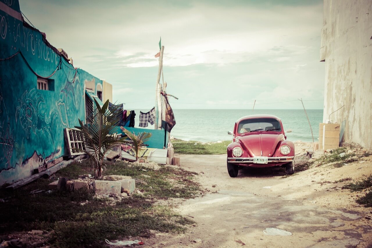 an abandoned car near a house