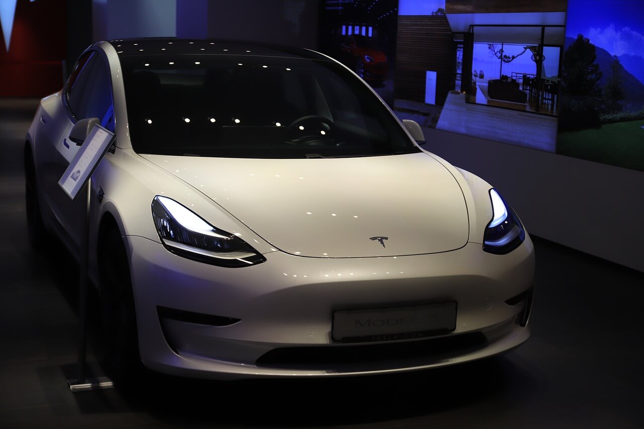 a Tesla car near a charging station