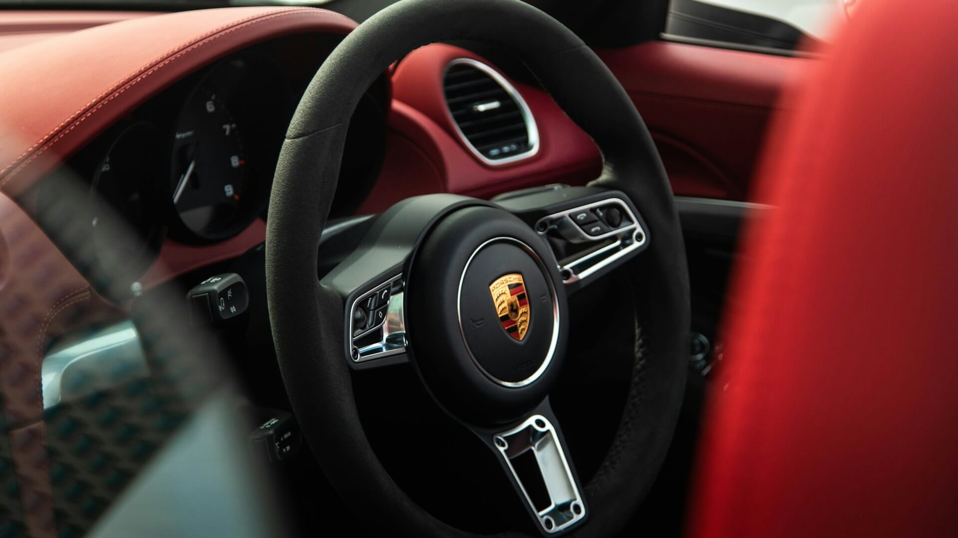 close-up of a steering wheel in a luxury Porsche car