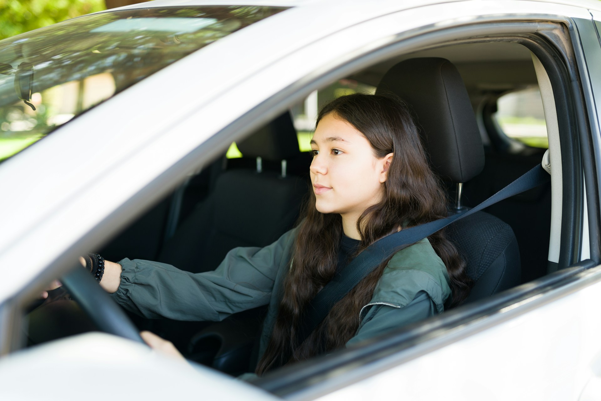 teenage driver at the wheel of a car