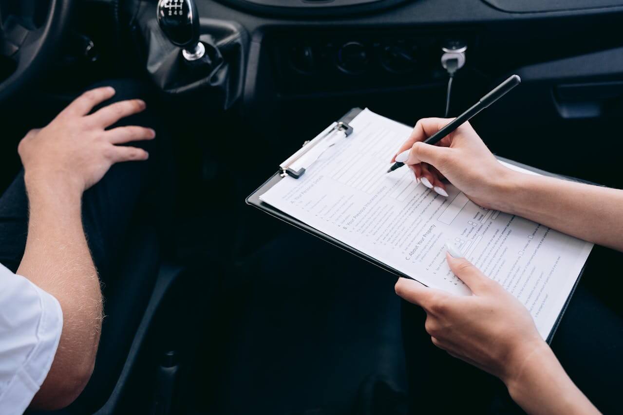 an insurance agent checks the car