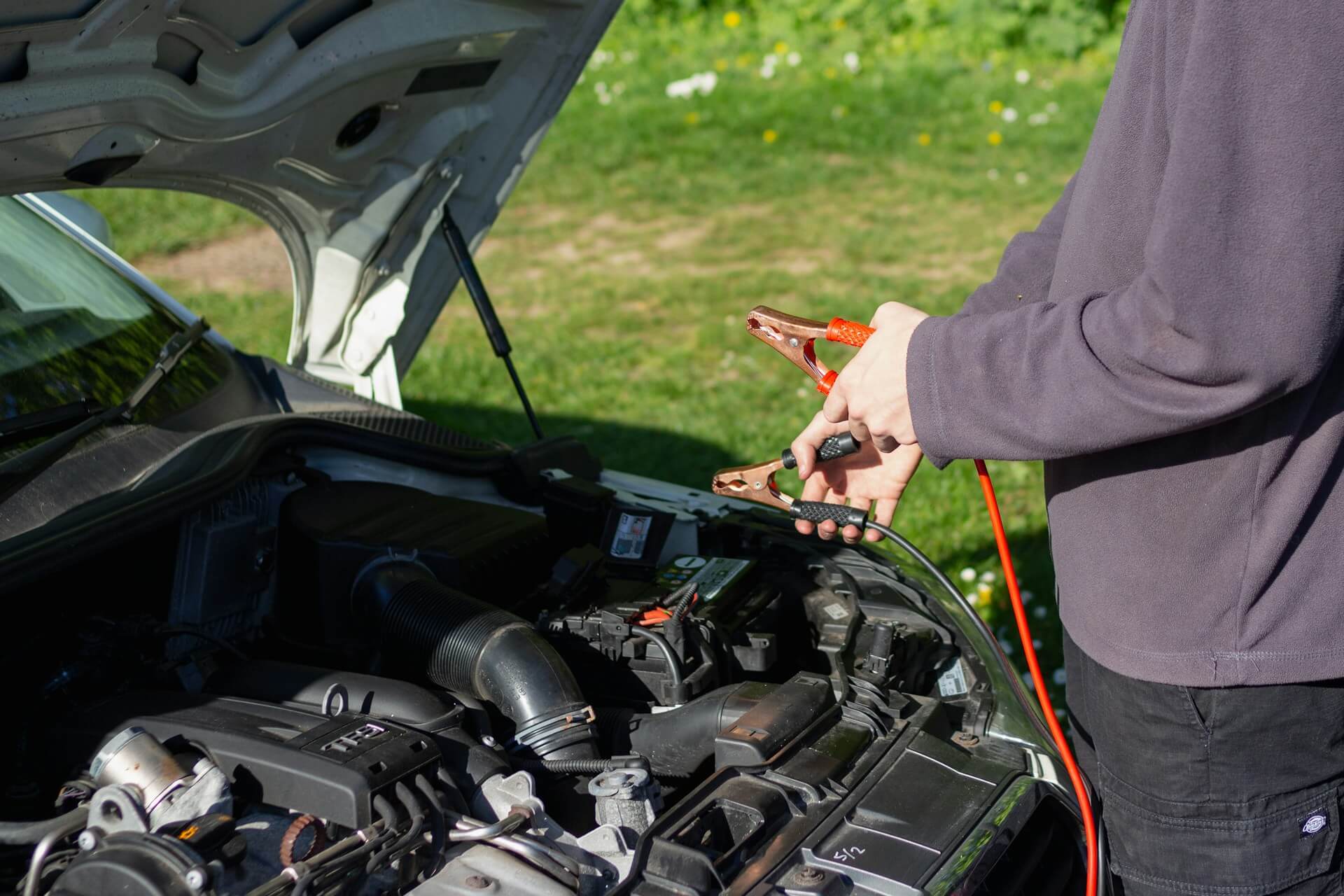 a driver trying to jumpstart a car