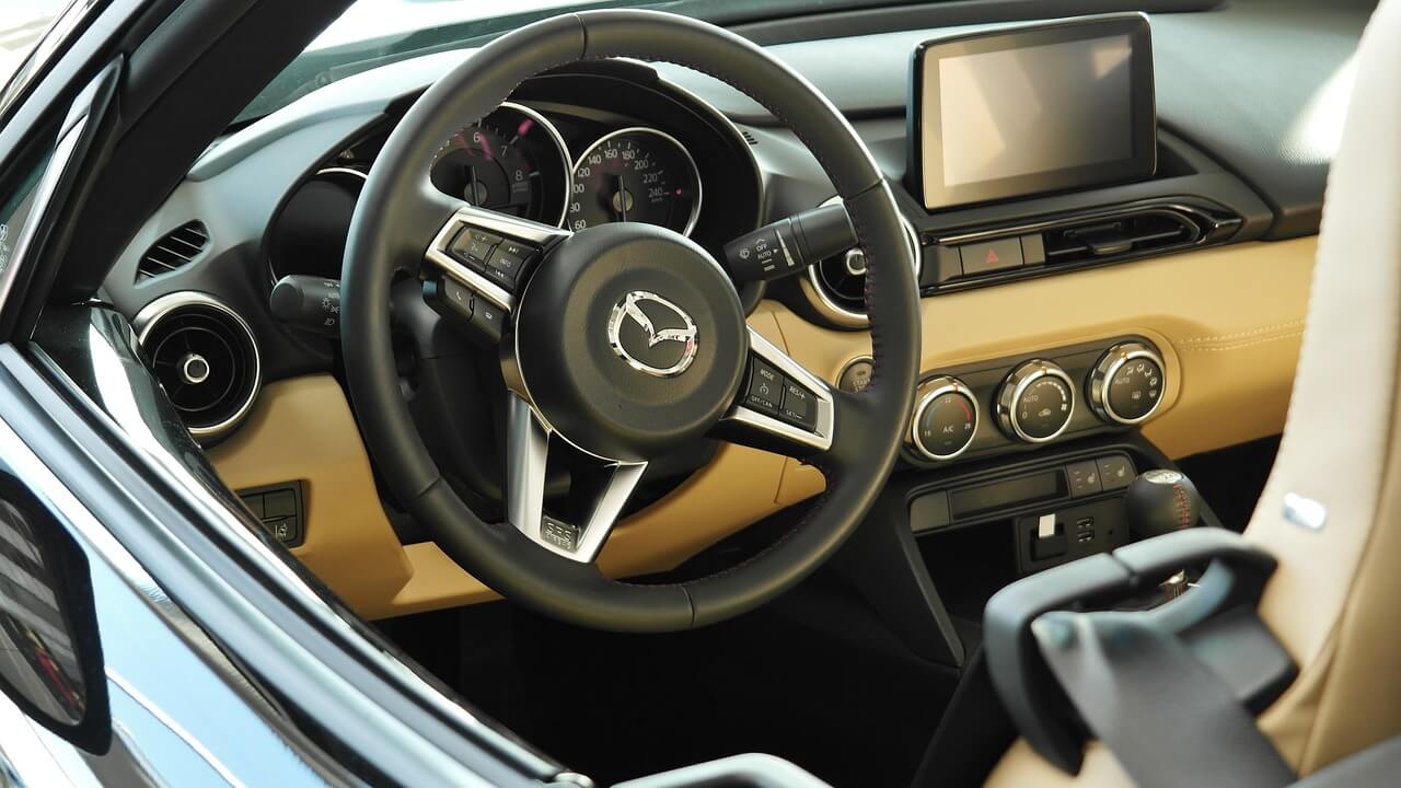 a steering wheel and an entertainment system in a Mazda vehicle