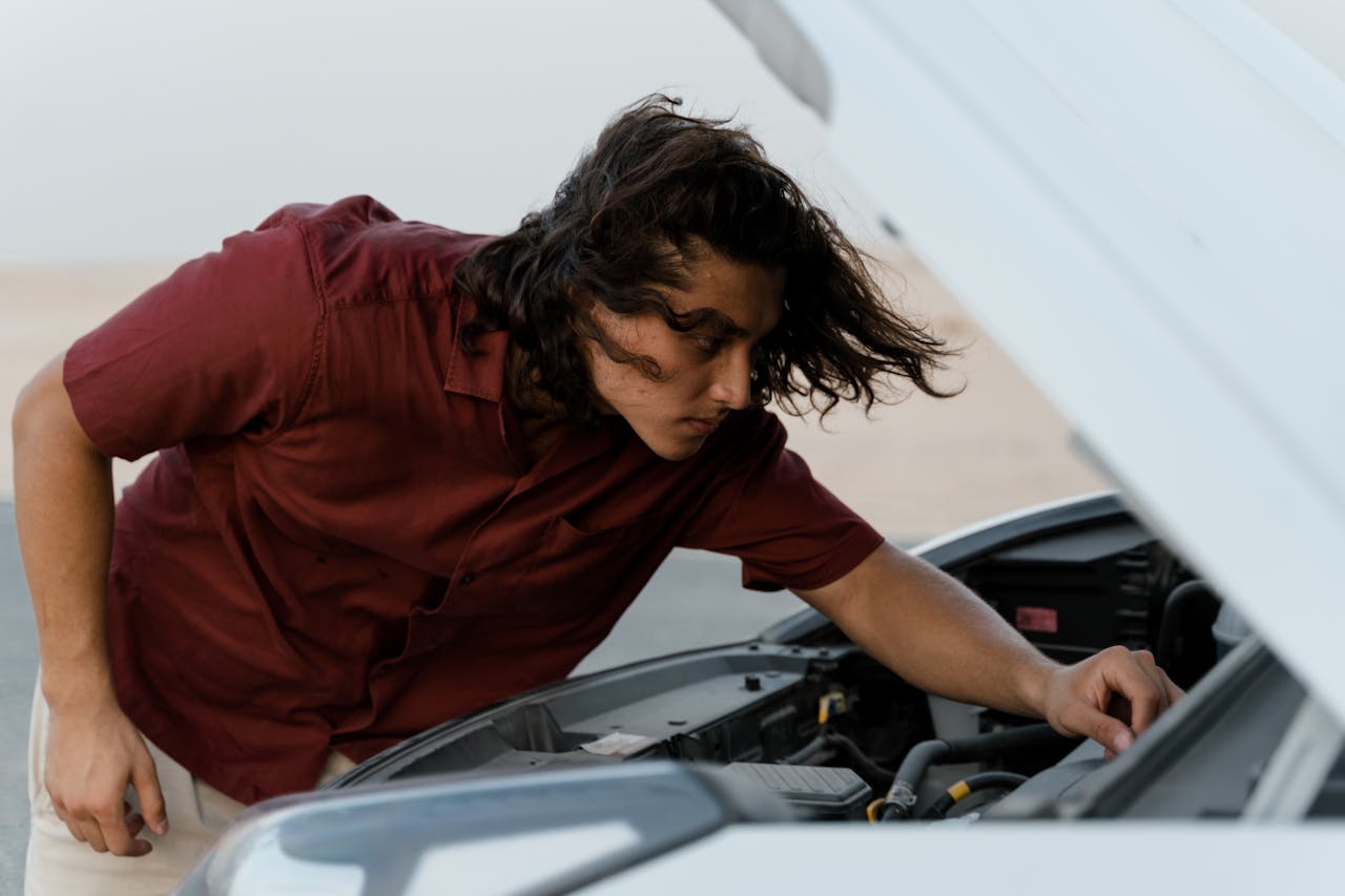 A man checking his car's engine