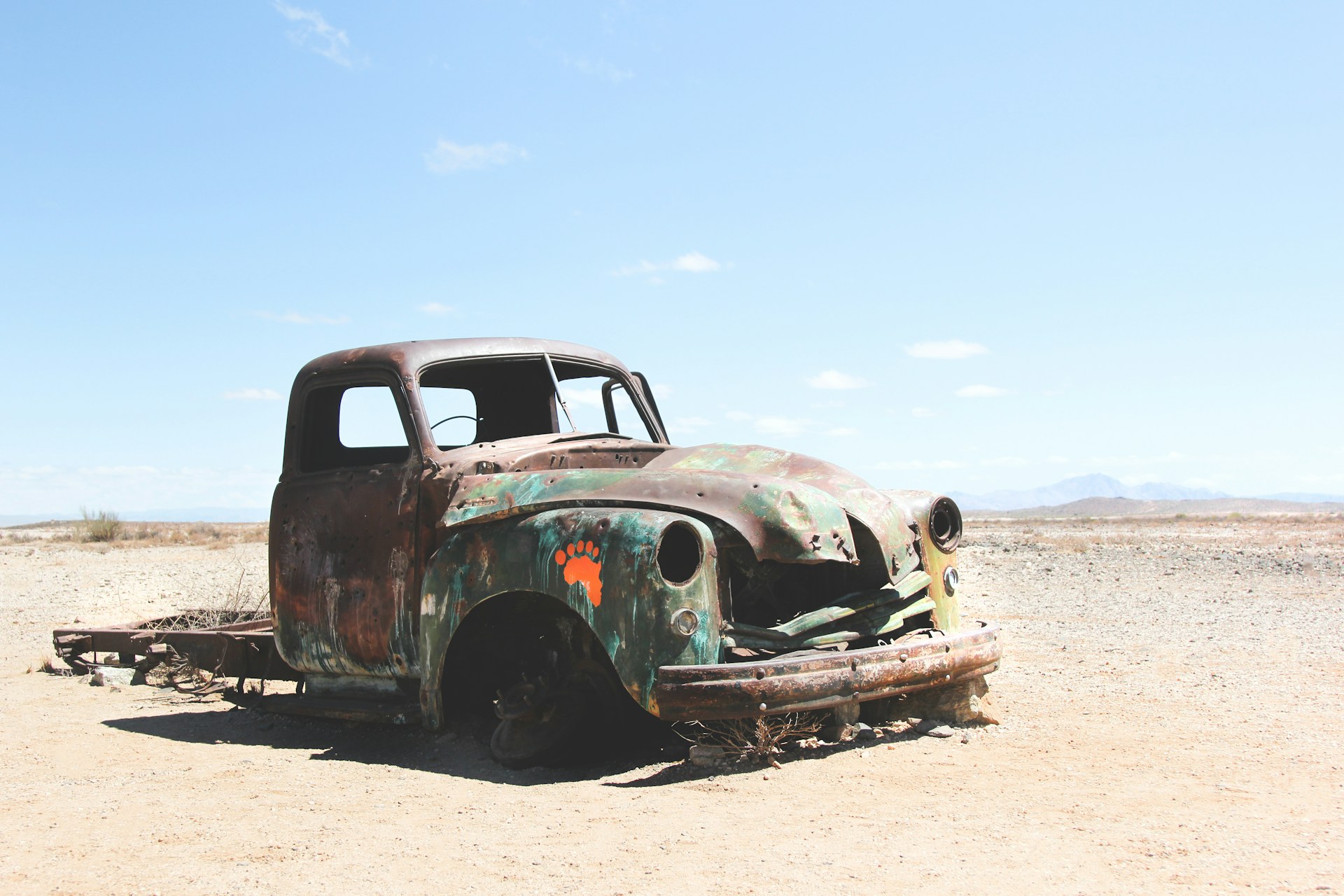 rusty car on the side of the road